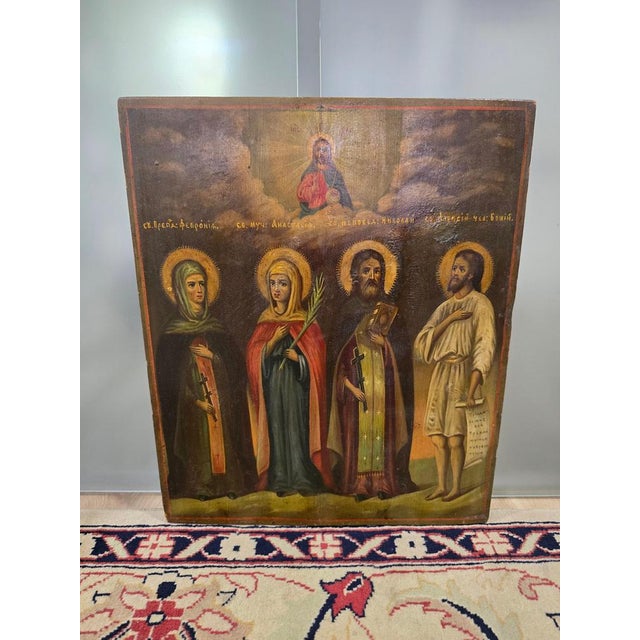 Presenting a magnificent 19th-century Orthodox icon depictingFour Saints. This piece is painted in tempera on a wooden...