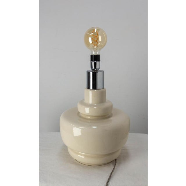 Vintage table lamp mounted on a terracotta base, The light support is made of chrome. The clean lines of this item are...