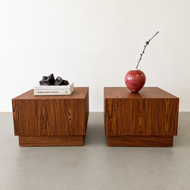 A striking pair of vintage Mid-Century Modern rosewood end tables featuring beautifully figured wood grain and a clean,...