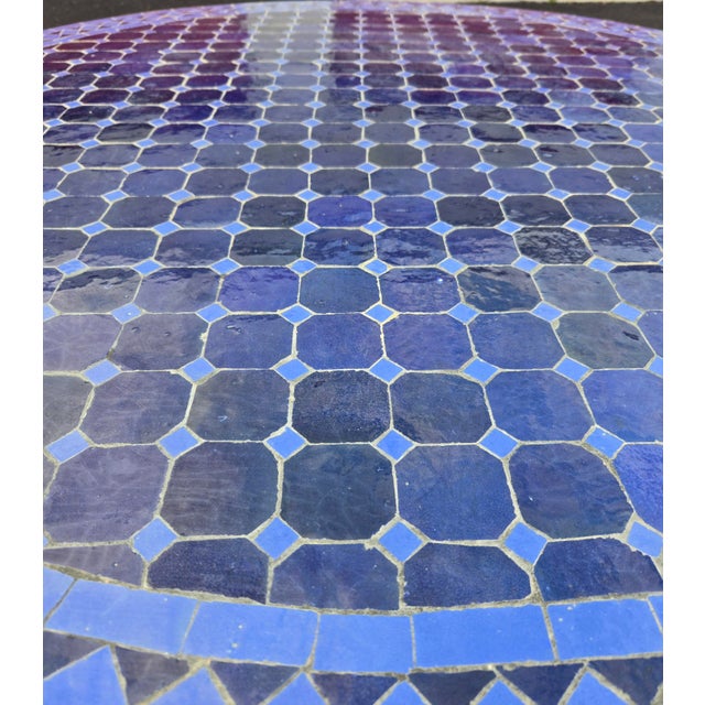 Beautiful handcrafted Moroccan mosaic table featuring an elegant blue color palette. Measuring 48 inches in diameter, this...
