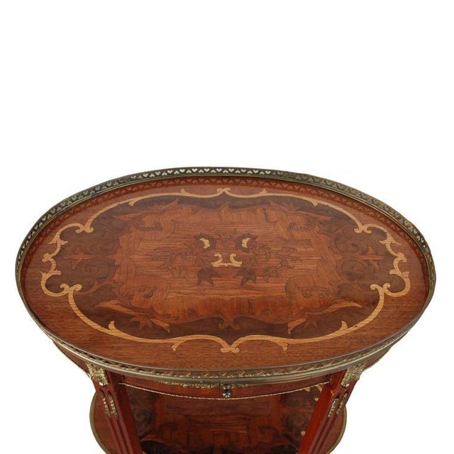 Antique French Art Nouveau Side Table This piece features intricate marquetry inlays with a beautiful metal gallery edge....