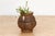 This carved marble vase takes a more architectural approach: a bulbous, faceted body rises to a carved collar of pointed...