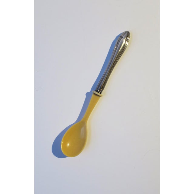 A sterling silver and celluloid baby spoon, circa early-20th century. Piece has a sterling silver handle and celluloid...