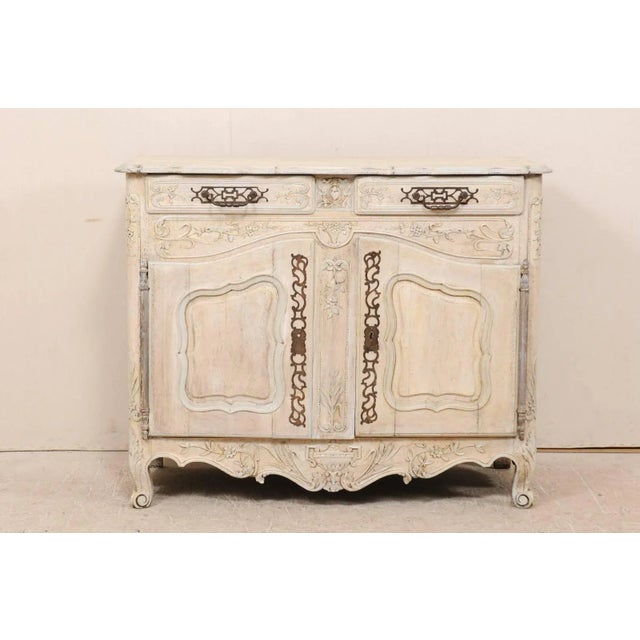 A French, 19th century carved and painted wood buffet. This French wood buffet features two drawers over two doors. The...