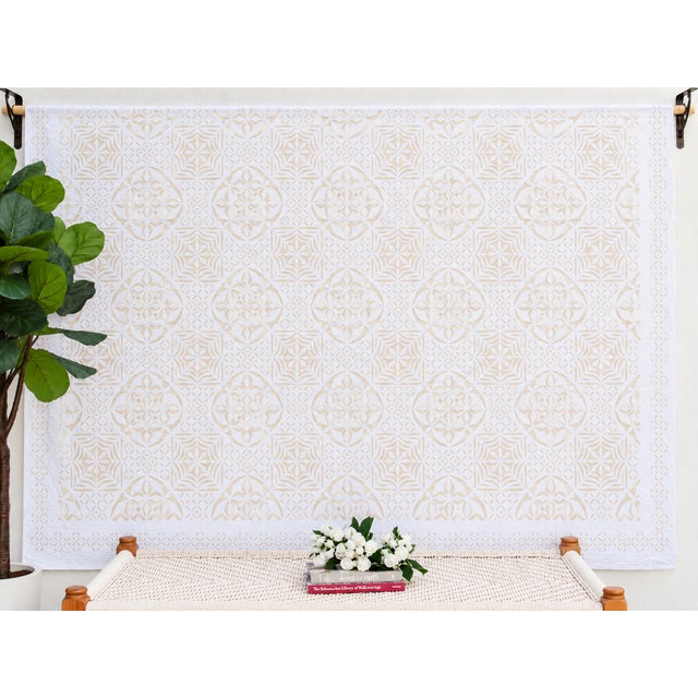 A lightweight cotton coverlet from Western India, beautifully adorned with intricate handcrafted appliqué cutwork. The...