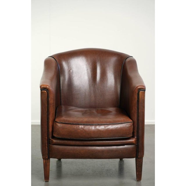 This subtle sheepskin armchair features beautiful deep brown colors and is finished with black piping. The armchair has a...