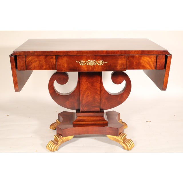 Russian neo classical style flame mahogany and gilt decorated writing / sofa table, late 20th century. With a flame...