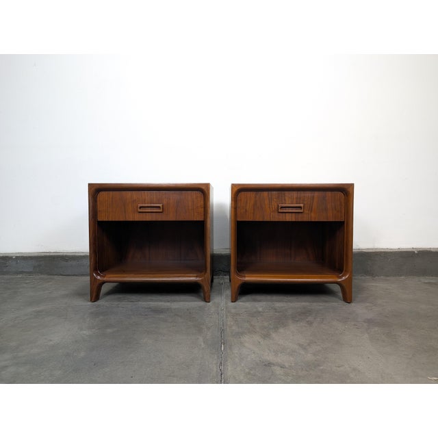 Exceptional pair of mid century modern walnut nightstands by Widdicomb, showcasing the same iconic sculptural design...