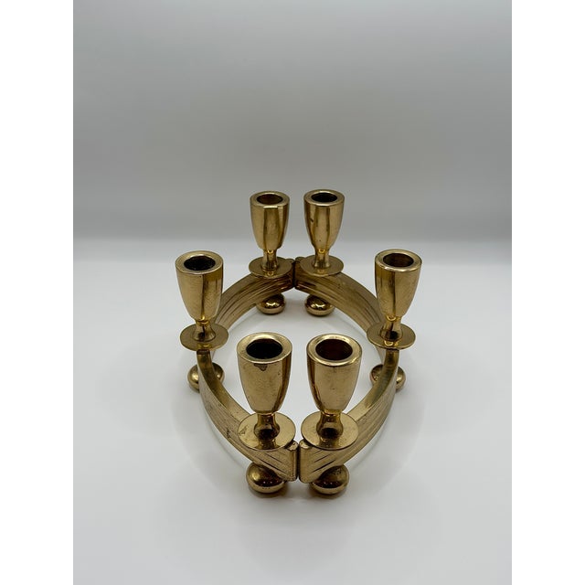 A sculptural vintage Dirilyte candelabra set with a warm gold tone finish and a beautifully architectural presence....