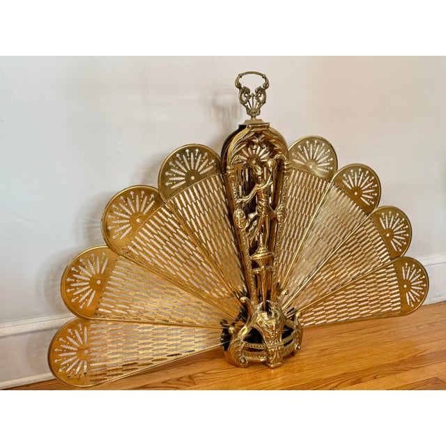 Oversized antique Victorian brass peacock fireplace screen which stands 48" wide when open. Adorned with classical motif....