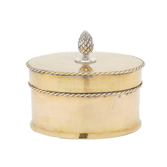 Late Georgian period oval brass tea caddy with applied rope edging on the upper edge of the lid and the rim. Centered on...