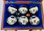 Vintage petanque or bocce ball set featuring six chrome-plated metal boules with engraved striped patterns, a small wooden...