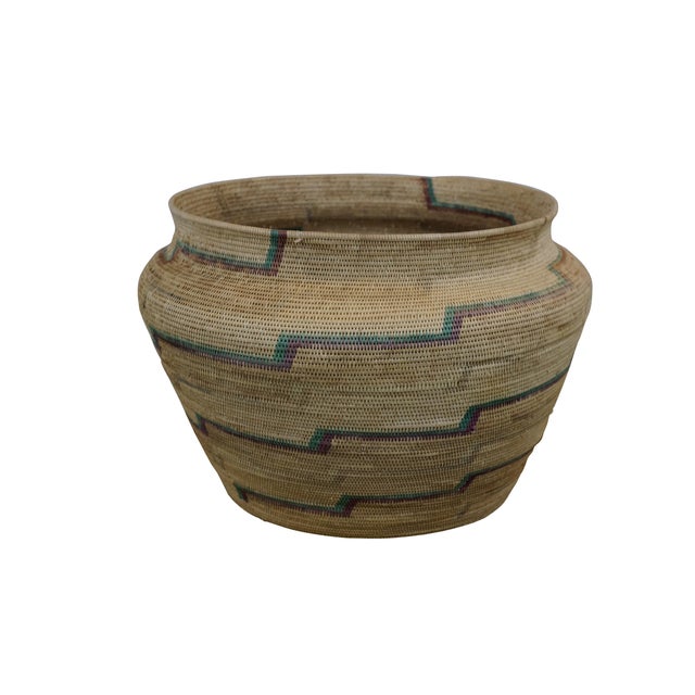 Late 20th century palm leaf basket vase / urn, hand woven in natural beige with a meandering stripe of purple and teal...