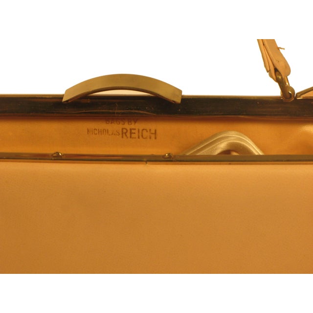 Nicholas Reich is an American handbag maker since the 1950's. Their trademark frames are scalloped, winged, set with many...