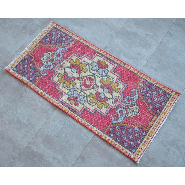 a Vintage Turkish Small yastik rug, red background rug perfect for entryway, bath or in front of the kitchen sink....