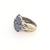 Made circa 1980 to 2000, this ring is defined by a clear cornflower blue, set with seven prong set cabochon blue...