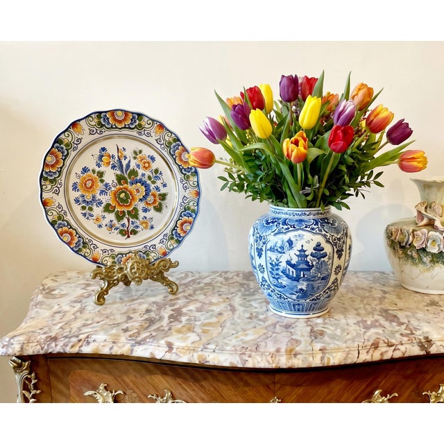 A beautifully hand-painted Delft Polychrome wall plate from Holland, dating to the mid-20th century. Executed in a richly...