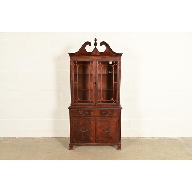 A beautiful Chippendale or Georgian style lighted breakfront bookcase or dining cabinet In the manner of Baker Furniture...