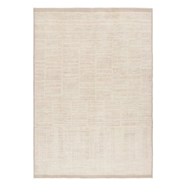 This 9x12 modern textural rug by Rug & Kilim in cream-white tones, has been hand-knotted in wool and speaks to our design...