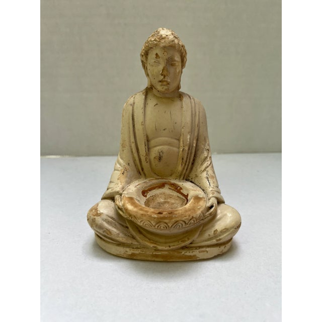 A single antique seated Buddha figurine with bowl in lap. Features a wonderful chalky finish with patina.