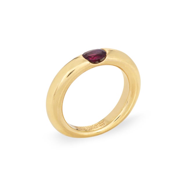Vintage Cartier ruby 'Ellipse' ring crafted in 18k yellow gold (circa 1992). Oval faceted ruby measures 5mm x 4mm (note:...