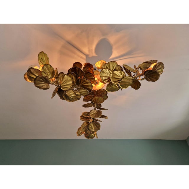 Large brutalist brass chandelier, 3 arms, floral design, 1970s. a rare and highly decorative piece. this chandelier is...
