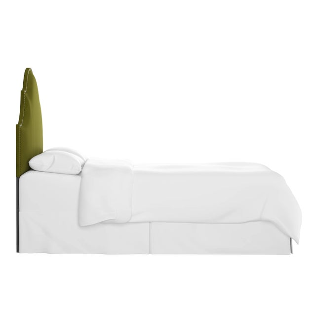 Classic curves wrapped in smooth upholstery, then accented with elegant ornamental nailheads, gives this Upholstered...
