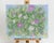 This acrylic floral painting adds uplifting charm to any space. Featuring a brilliant group of colorful wildflowers on a...