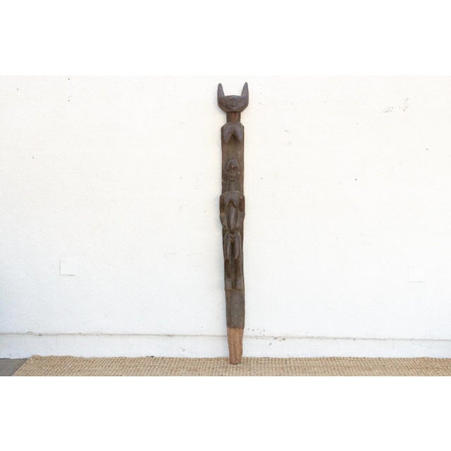 This commanding African wooden sculpture is a powerful piece of architectural history and spiritual art. This Ancient...