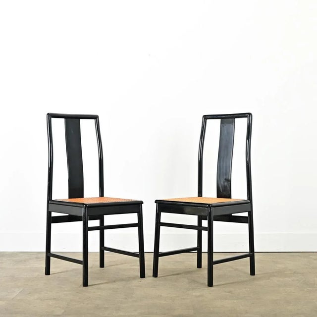 A fabulous set of six, vintage Italian-made dining chairs with black lacquer frames and woven cane seats for a modern yet...