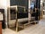 Brass étagère with smoked glass shelves. This piece stands out for its unique and sophisticated geometric design,...