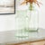 Bring fresh elegance to your space with this Sage Green Glass Vase. Standing 10.25 inches tall, this beautifully crafted...