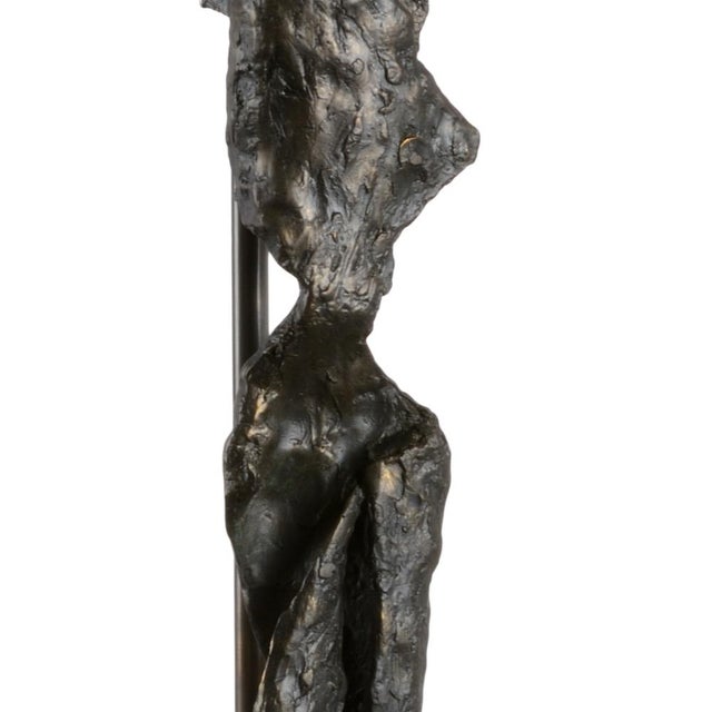 Bring a piece of museum quality art to your home. This aged dark bronze elongated sculpture with simple modern lines is...