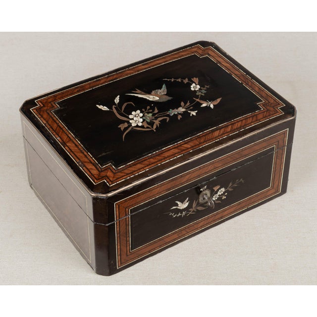 A 19th Century French Napoleon III marquetry box, hand-crafted of walnut and burl veneers and ebonized panels. Fine...