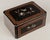 A 19th Century French Napoleon III marquetry box, hand-crafted of walnut and burl veneers and ebonized panels. Fine...