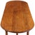 An unusual mid-century French oak table, circa 1950, featuring a long oblong top with gracefully rounded ends. The...
