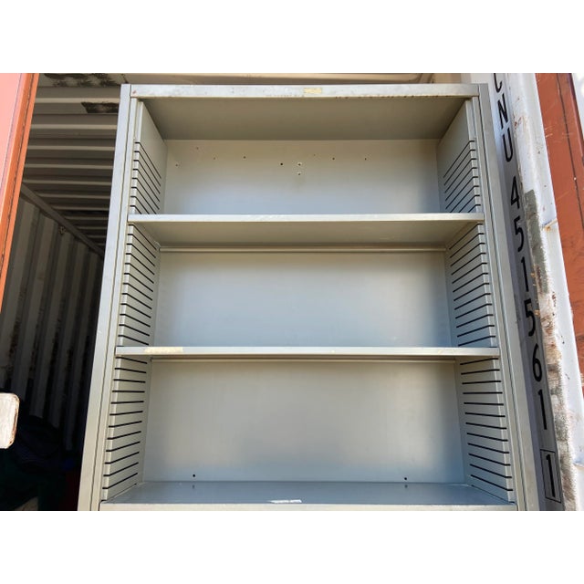 Vintage mid century modern tall metal bookshelf with adjustable shelves it has some screw wholes to secure the bookcase...