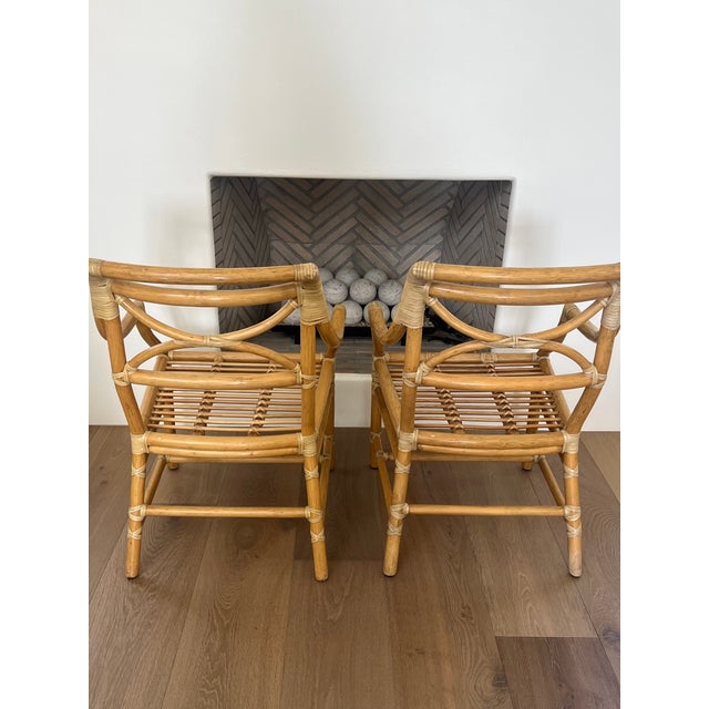 Authentic vintage McGuire armchairs featuring the brand’s signature bamboo/rattan construction with leather-wrapped...