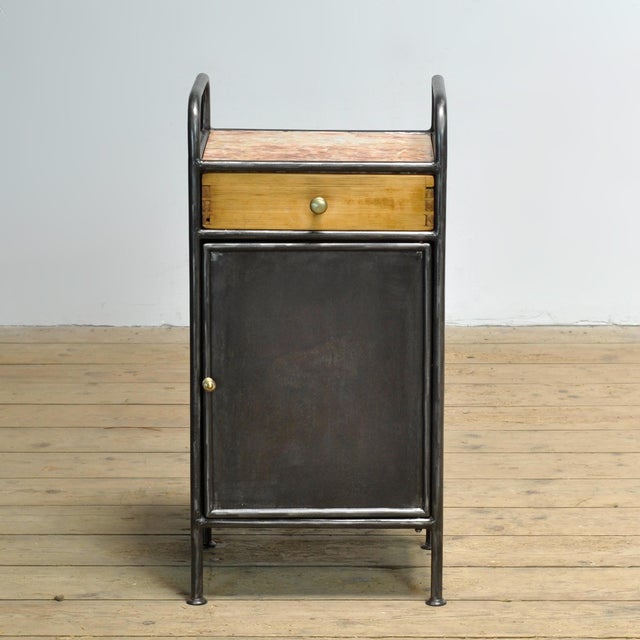 This nightstand from circa 1920 combines an industrial look with refined authentic details. The piece of furniture is...