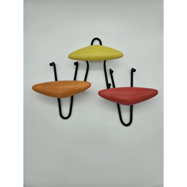 Set of three vintage hangers in colored resin with iron structure. Normal signs due to age and use.