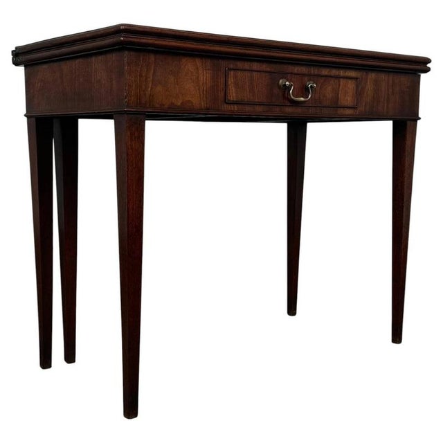 A handsome 19th-century English tea table, finely crafted from mahogany and distinguished by its elegant proportions,...