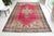This is a vintage Turkish Oushak rug from the Mid 20th Century. The piece was hand-knotted.