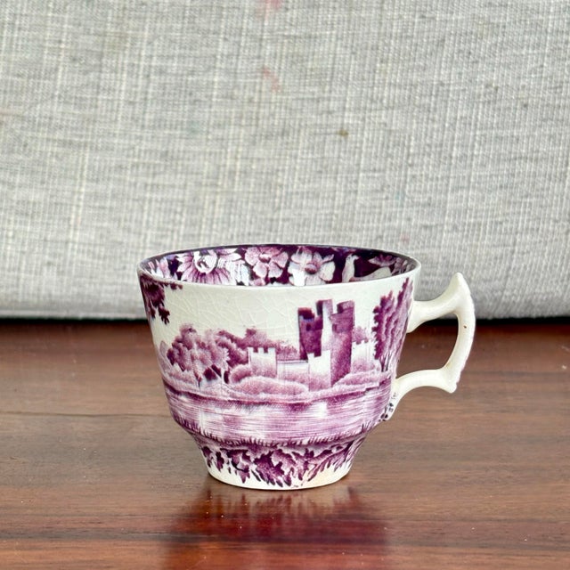 A charming vintage demitasse cup by Enoch Woods & Sons in the “Castles” pattern, featuring a romantic purple transferware-...