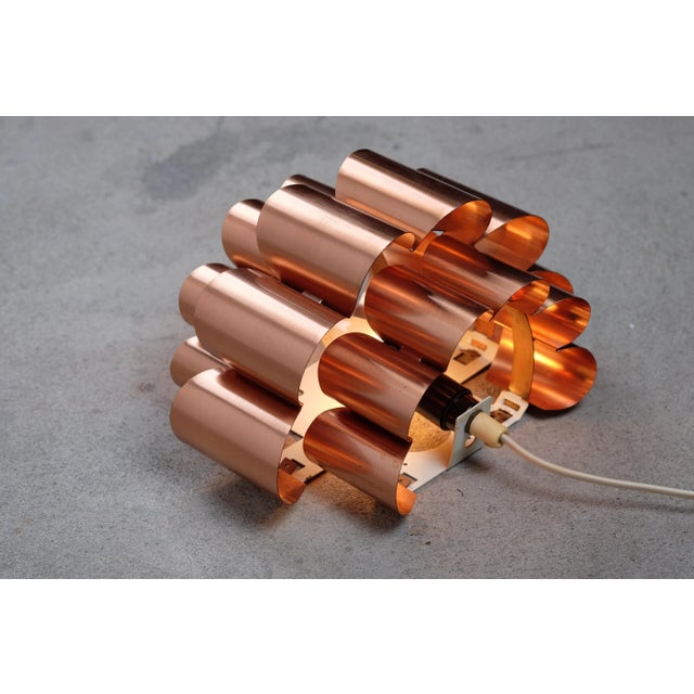 This beautiful wall lamp, designed by Werner Schou, is made of copper. The wave formed structure provides great light. I...