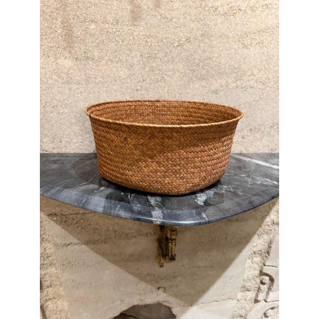 For your consideration, a woven storage basket, also commonly referred to as a wicker basket. It is made by weaving...