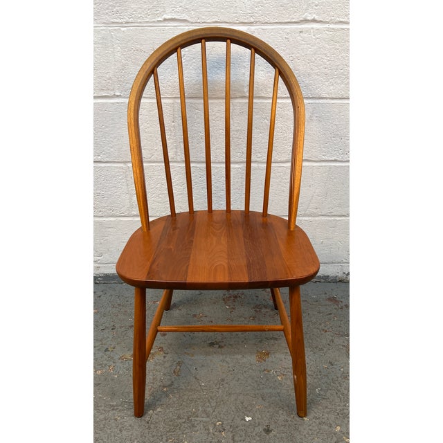 Bring timeless Scandinavian design to your dining space with this beautiful set of four Mid-Century spindle-back dining...