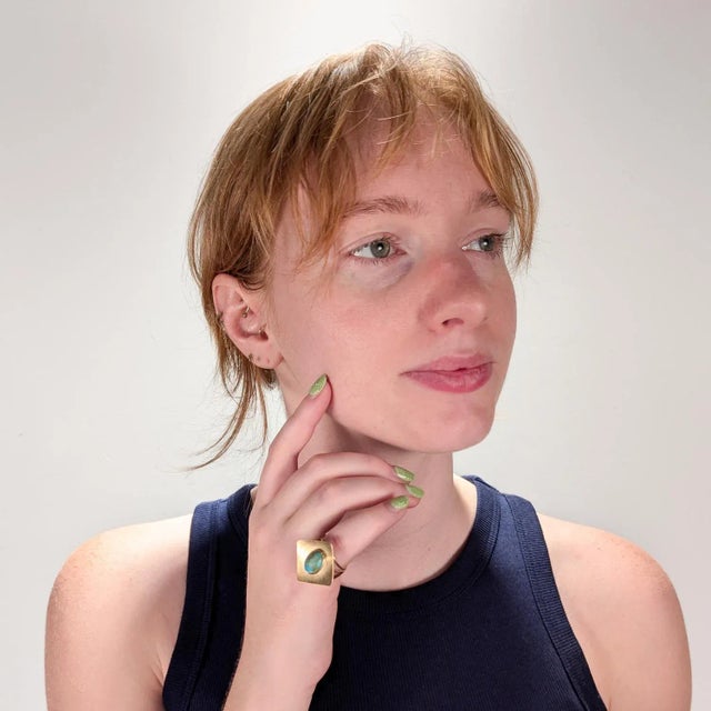 A fine Mid-Century studio cocktail ring. In 14k yellow gold. With a bezel set, hand cut turquoise cabochon center set on a...