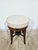An antique Victorian piano stool from the 19th century, made of solid wood with a deep, warm shade. The classic design is...