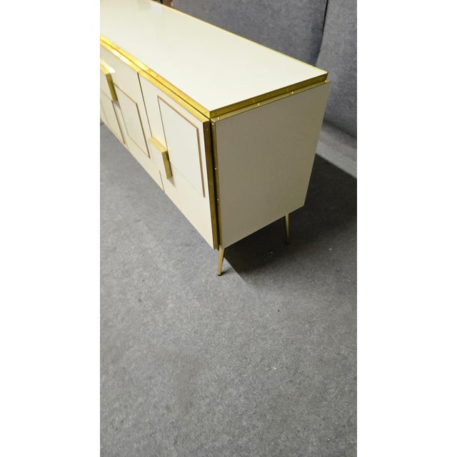 The 4-door Italian sideboard with Murano glass, solid wood and brass is a true highlight for any sophisticated interior....