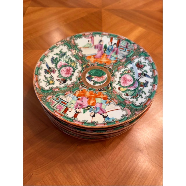 Stunning set of 7 Famille Rose plates with beautiful green, blue, yellow, orange, and rose. Each is exquisitely painted in...